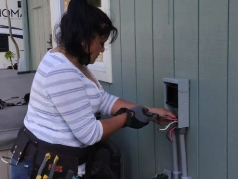 Licensed electrician wiring an exterior subpanel in Wilson